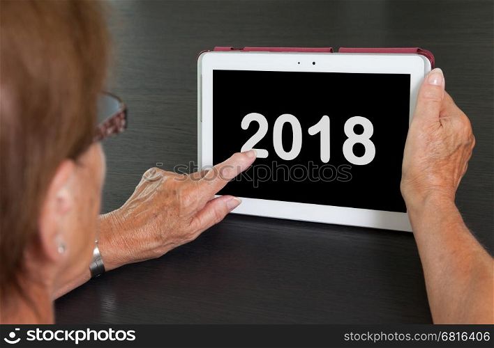 Senior lady relaxing and her tablet - New year - 2018