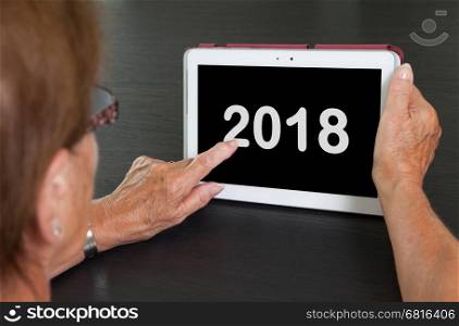 Senior lady relaxing and her tablet - New year - 2018