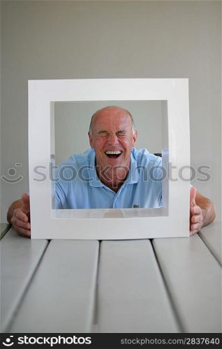 senior looking through a picture frame