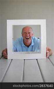 senior looking through a picture frame