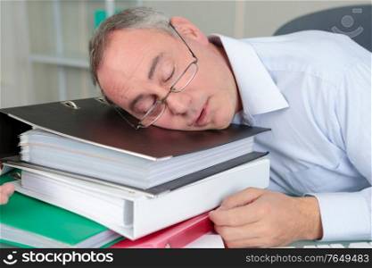 senior male accountant sleeping on the table