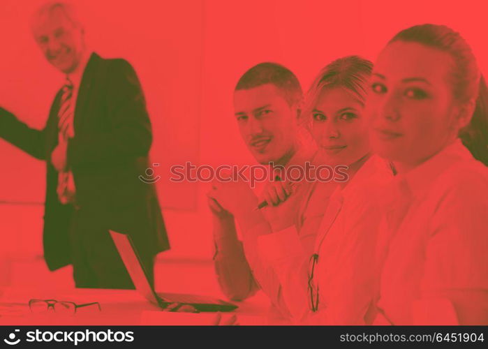 Senior male business man giving a presentation at a meeting at modern light office on a table board