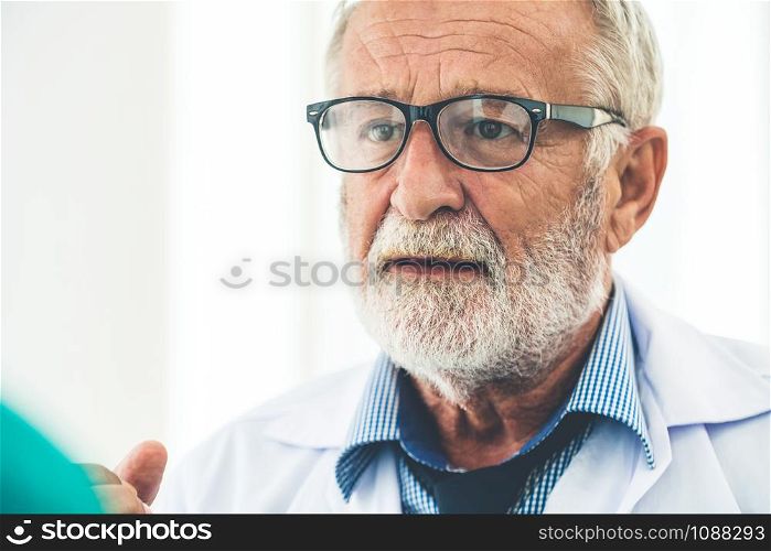 Senior male doctor working in hospital. Medical healthcare and doctor service.