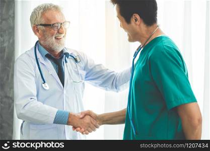 Senior male doctor working with another doctor in hospital. Concept of medical healthcare and doctor staff education.. Senior male doctor working with another doctor.