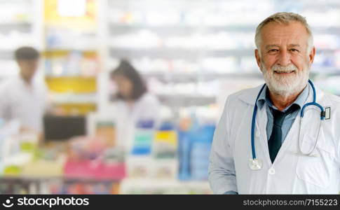 Senior male pharmacist working at the pharmacy. Medical healthcare and pharmaceutical service.