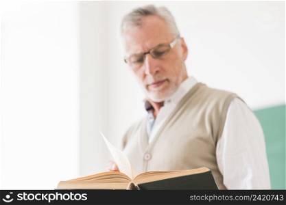 senior male professor glasses reading book