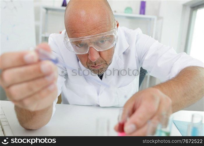 senior male scientist conducting an experiment