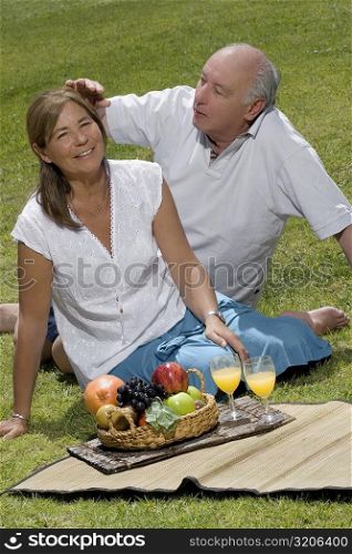 Senior man adjusting the hair of a senior woman
