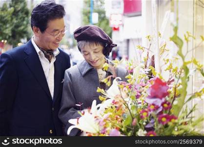 Senior man and a mature woman looking at flowers