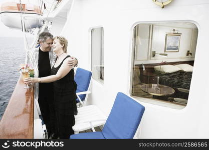 Senior man and a mature woman romancing on a sailing ship