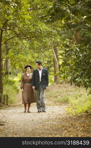 Senior man and a mature woman walking in the park