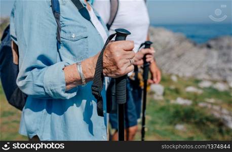 Senior man and woman practicing trekking outdoors. Senior couple practicing trekking outdoors