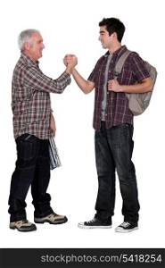 Senior man and young man handshaking