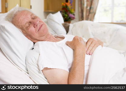 Senior Man Asleep In Hospital Bed