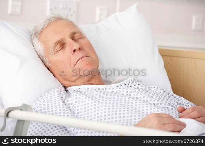 Senior man asleep in hospital bed