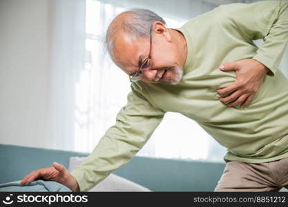 Senior man bad pain hand touching chest having heart attack, Asian older man have congenital disease suffering from heartache alone at home his heart aches, Old age retirement health problems diseases
