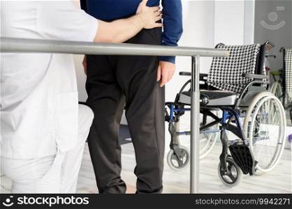 Senior Man Being Assisted By Physiotherapist In Rehab Center. High quality photo. Senior Man Being Assisted By Physiotherapist In Rehab Center.