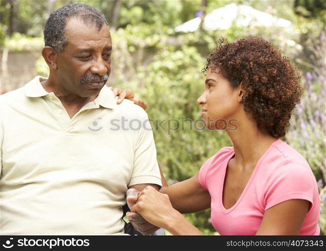Senior Man Being Consoled By Adult Daughter