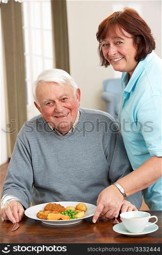 Senior Man Being Served Meal By Carer