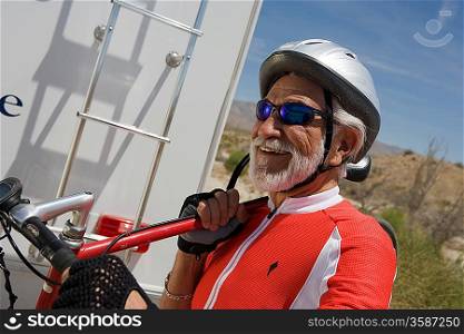 Senior man carrying bike