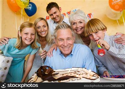 Senior man celebrating birthday with family
