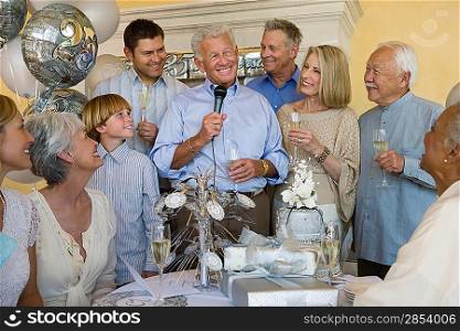 Senior man celebrating start of retirement with family and friends