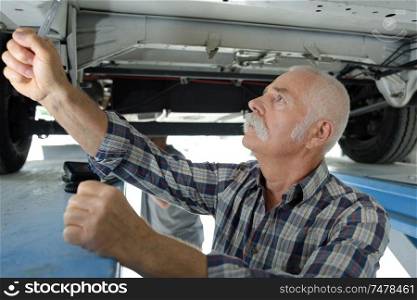 senior man checking a car