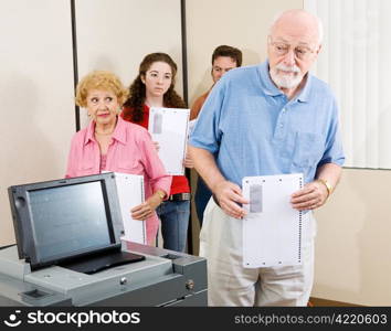 Senior man confused by new optical scan voting machine.