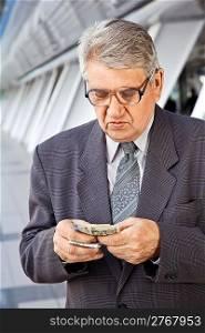 Senior man counting money