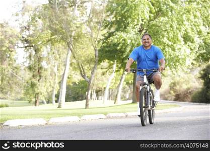 Senior Man Cycling In Park