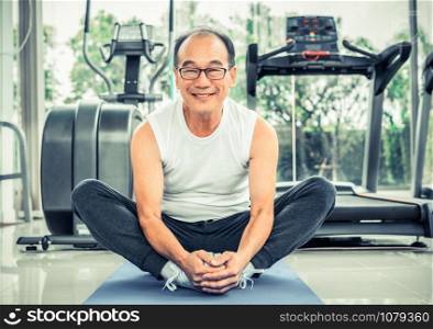 Senior man do body stretching in fitness center. Healthy lifestyle.