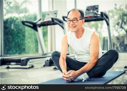 Senior man do body stretching in fitness center. Healthy lifestyle.