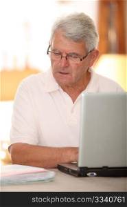 Senior man doing tax return on internet