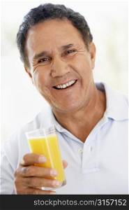 Senior Man Drinking Fresh Orange Juice
