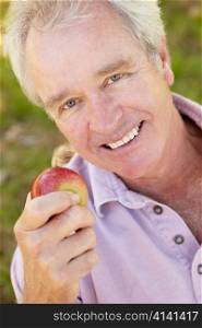 Senior man eating apple