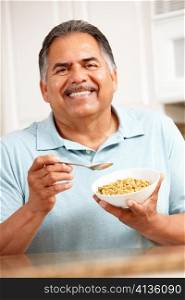 Senior man eating cereal