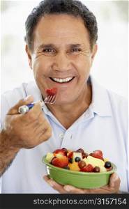 Senior Man Eating Fresh Fruit Salad