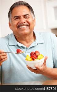 Senior man eating fruit