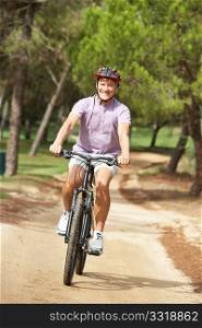 Senior man enjoying bike ride in park