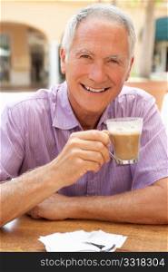 Senior Man Enjoying Coffee And Cake In CafZ