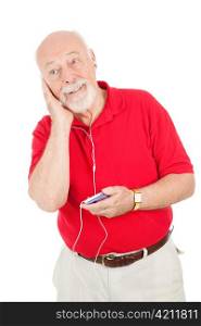 Senior man enjoys listening to his new MP3 player. Isolated on white.