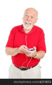 Senior man enjoys music on his mp3 player. Isolated on white.