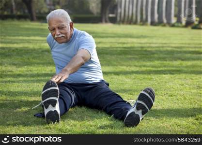 Senior man exercising in park