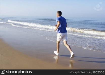 Senior Man Exercising On Beach