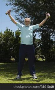 Senior man exercising with dumbbells