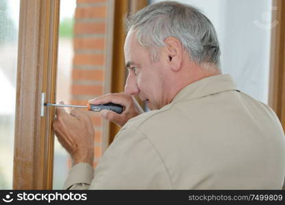 senior man fitting a window