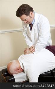 Senior man gets an adjustment to a friendly chiropractor.