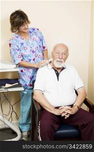 Senior man gets ultrasound therapy for his neck pain.