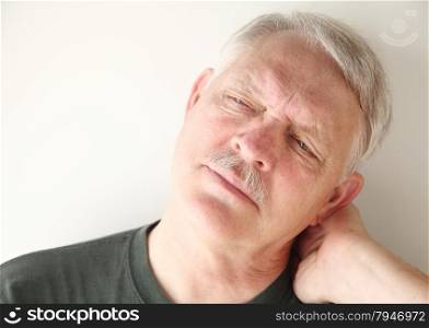 Senior man has a painful stiff neck.