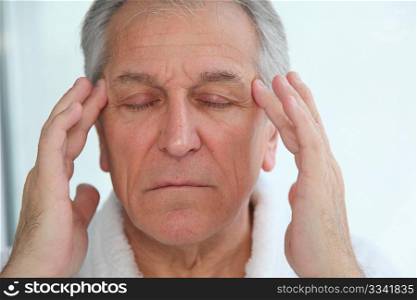 Senior man having a headache